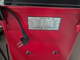an image of a red machine with a power cord plugged into it