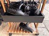 many hair dryers sitting in a box on a cart
