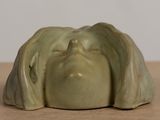 a close up of a ceramic figurine of a woman ' s face