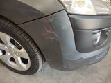 a close up of a car with a denting on it