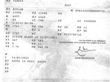 un vieux document sur lequel figure la photo d'un homme en costume-cravate