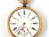 a gold pocket watch with roman numerals on it
