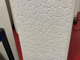a white refrigerator sitting on top of a red table