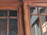 a clock on the top of a wooden door