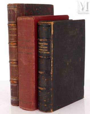three old books are stacked on top of each other on a table