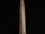 a bronze sculpture of a tall, pointed, pointed, pointed object on a black surface