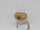 an image of a diamond and sapphire ring on a clear surface