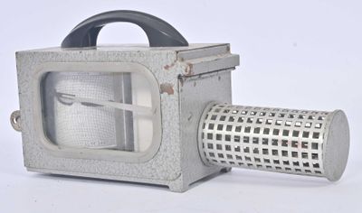 a small metal grater with a handle on a white background