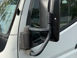 a white van with a mirror on the side of it