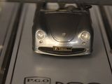 a silver toy car on display in a glass case