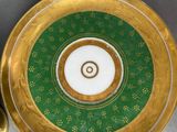 a plate with a gold rim and a green plate with a gold rim