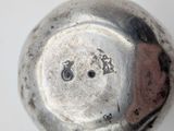 a close up of a metal object with a face on it