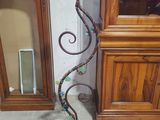 a tall metal candle holder with a decorative design on it
