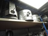 a shelf that has some metal pots and pans on it