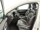the interior of a white car with black leather seats and a steering wheel