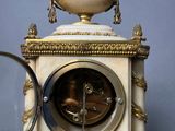 a clock that is sitting on a table with a magnifying glass