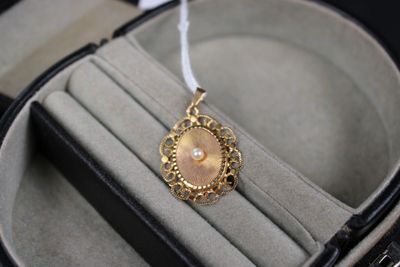 a necklace that is sitting inside of a case