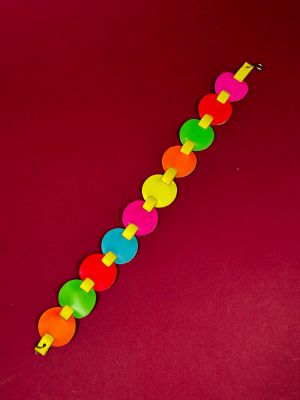 a close up of a colorful plastic toy on a red surface