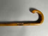 a wooden stick with a metal handle on a table