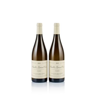 two bottles of wine sitting next to each other on a white surface