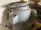 an old blender sitting on top of a wooden table