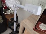 a white hair dryer sitting on a table next to a fire extinguisher