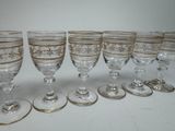six wine glasses are lined up in a row on a table