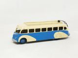 a toy bus that is sitting on a white surface