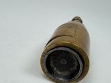 a small brass object that is on a white surface