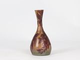an image of a brown and green vase sitting on a white surface