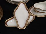 a lot of plates and bowls that are on a table