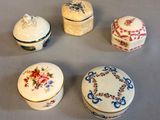 four small boxes with floral designs on them sitting on a table