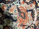 a large plate with a bird on it on a table