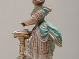 a figurine of a woman sitting on a table