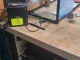 a laptop computer sitting on top of a workbench