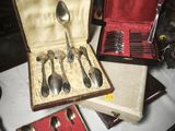a box with silver spoons and spoons in it on a table