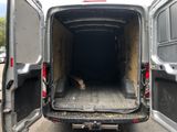 a white van with the door open in a parking lot
