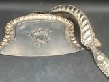a silver plate with a spoon on it on a table