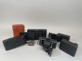 many pieces of luggage sitting on a white surface