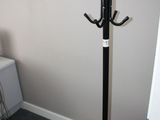 an image of a coat rack in the corner of a room