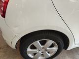 a picture of a white car parked in a garage