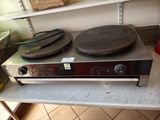 a stove with a pan on top of it in a kitchen
