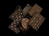 several different types of purses are arranged on a black surface