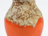 an orange and white vase with a black top on a white background