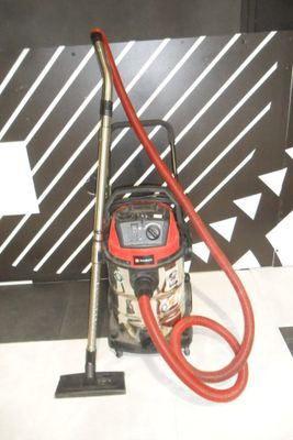 a red and black vacuum and a red hose on the floor