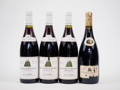 quatre bouteilles de vin sont alignées sur une surface blanche