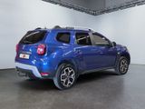 the rear end of a blue suv parked in a garage