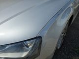 a close up of a car ' s headlight and front bumper