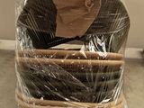 a stack of baskets wrapped in plastic on top of a pallet