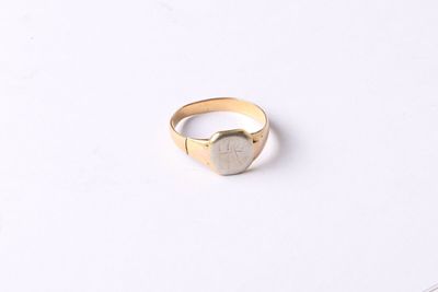 a close up of a gold ring with a heart on it